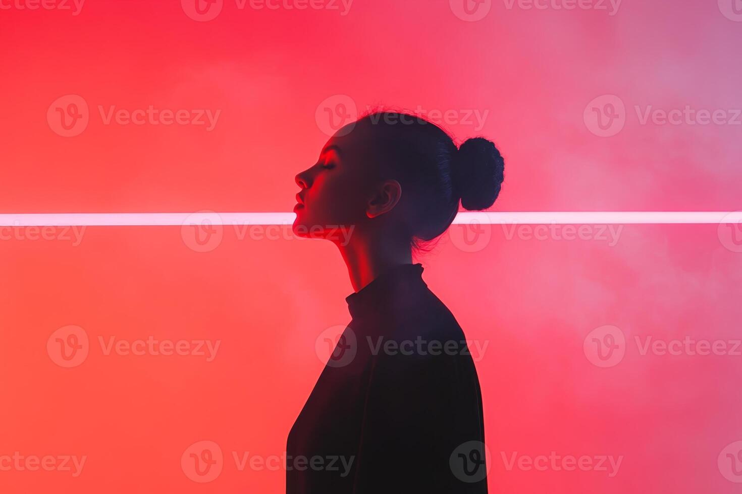 Woman silhouetted against vibrant red background with glowing line in urban setting photo