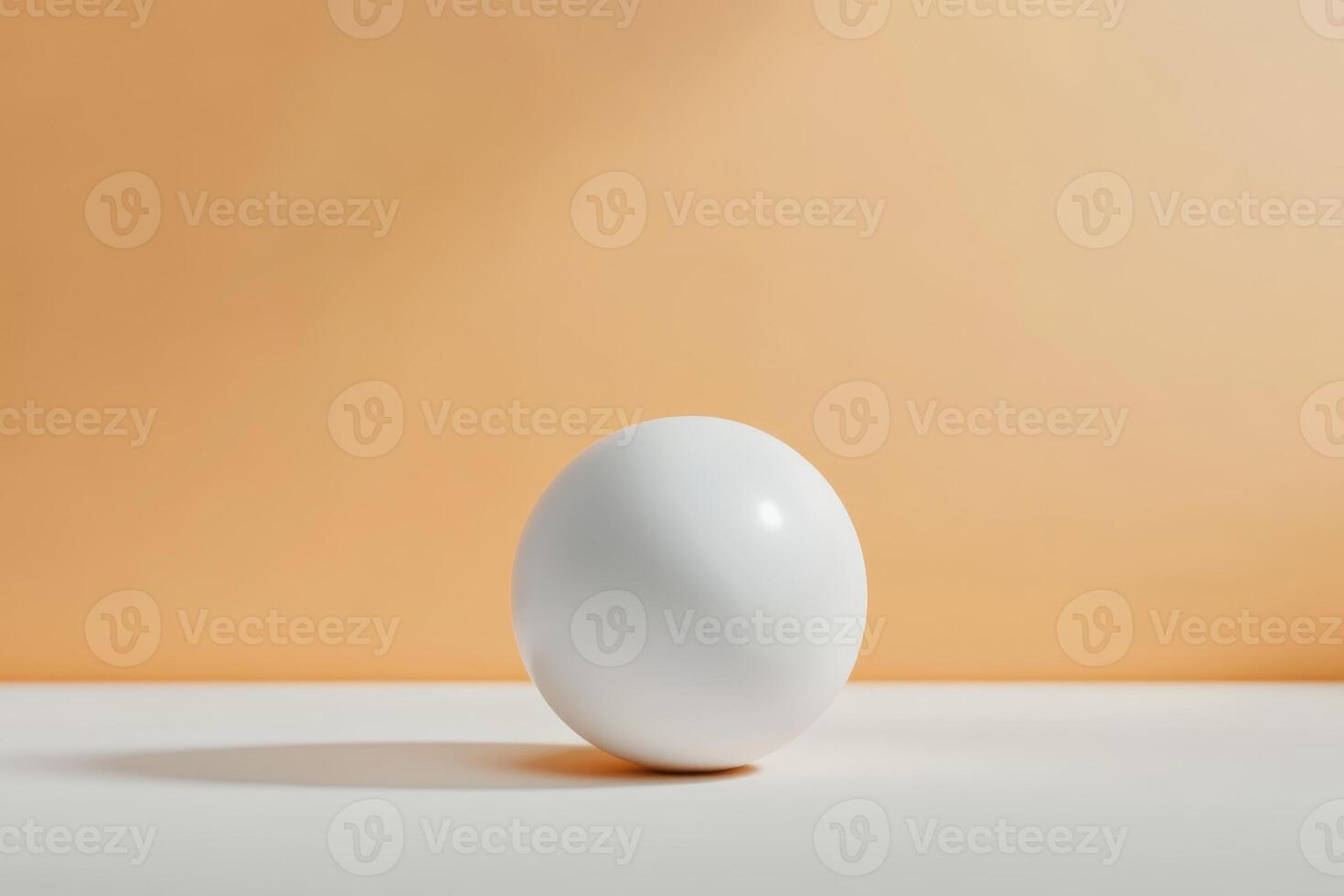 White spherical object resting on a light surface against a soft orange background during daylight photo