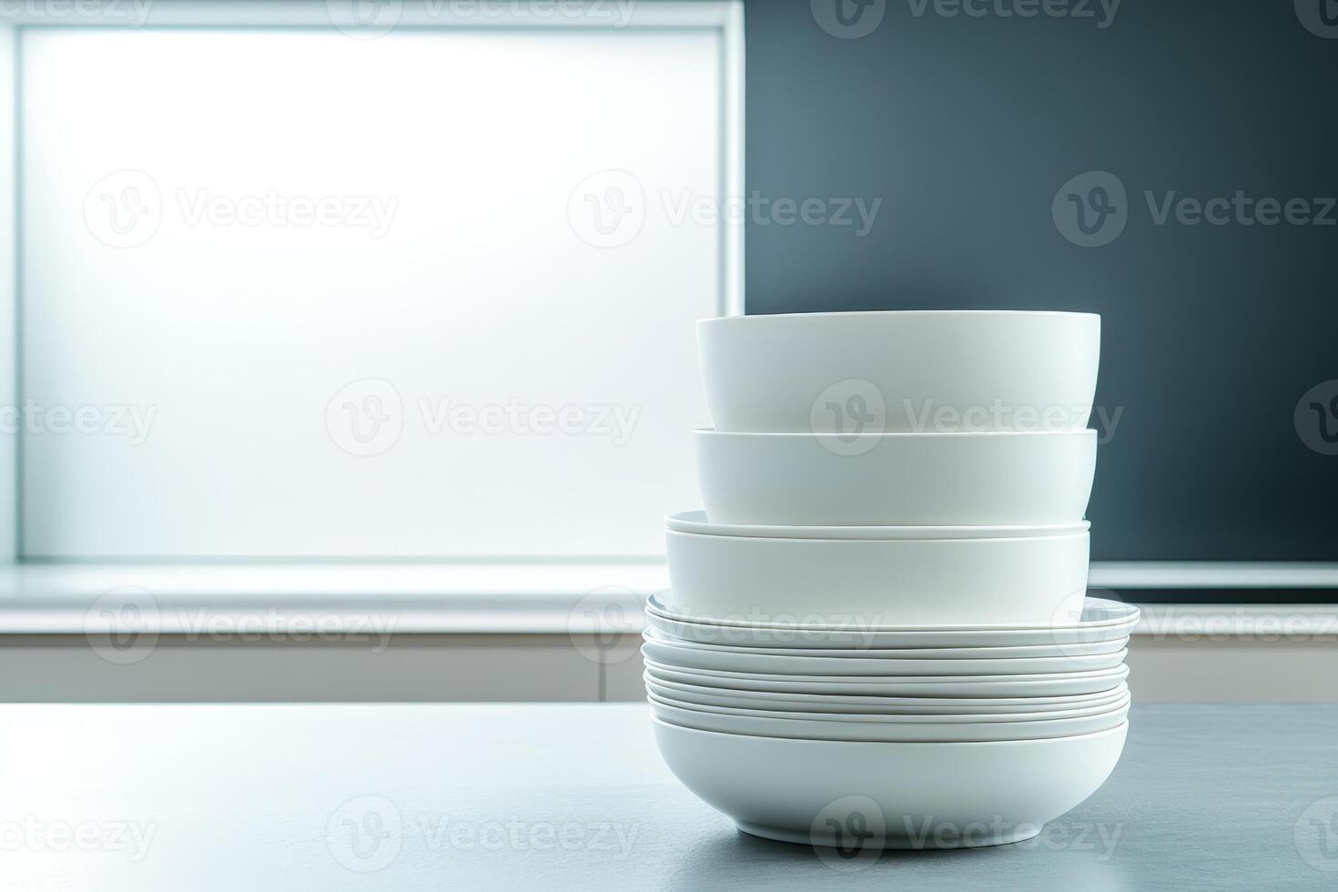 Stacked white ceramic bowls on a minimalist kitchen counter in a modern home setting photo