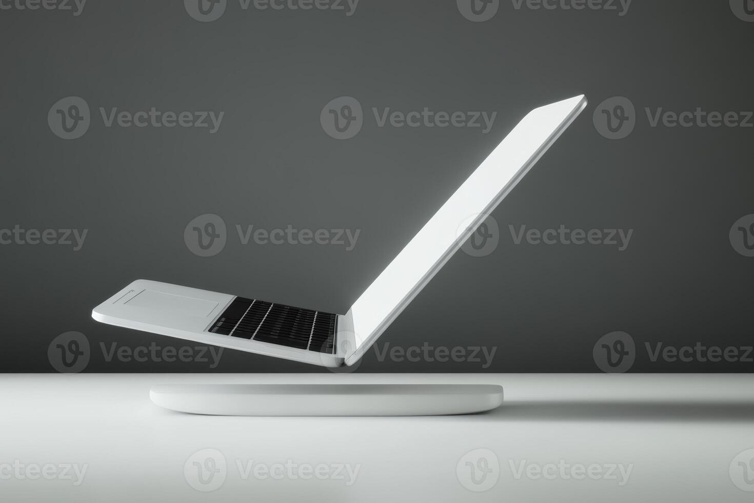 Laptop hovering above a sleek base showcasing modern technology in a minimalist setting photo