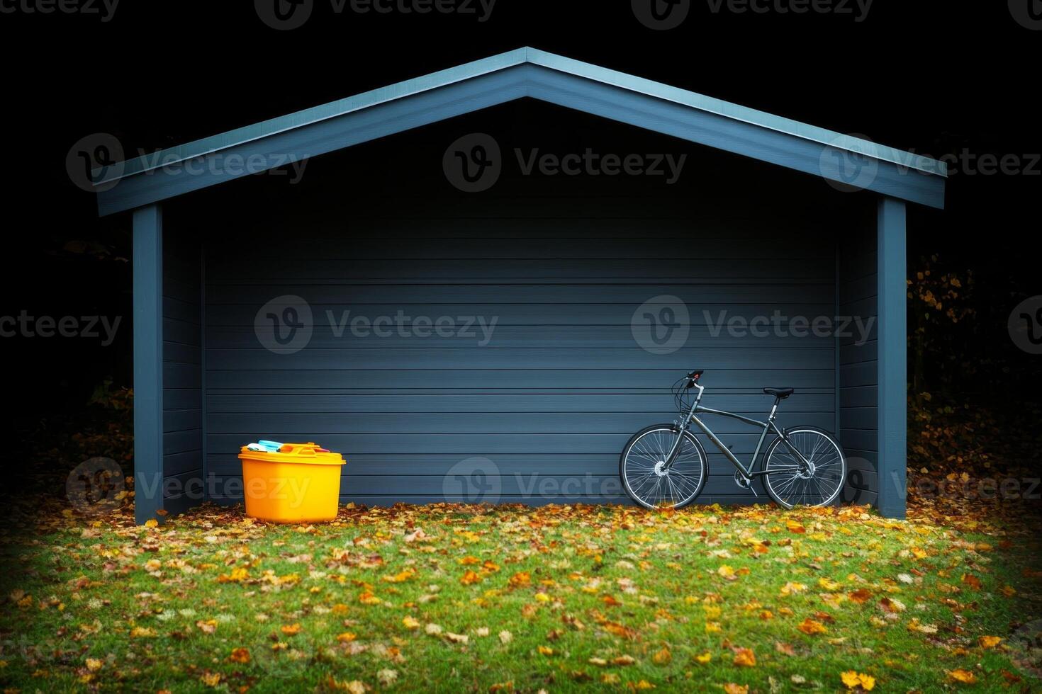 Bike parked next to a storage shed surrounded by autumn leaves during a sunny day photo