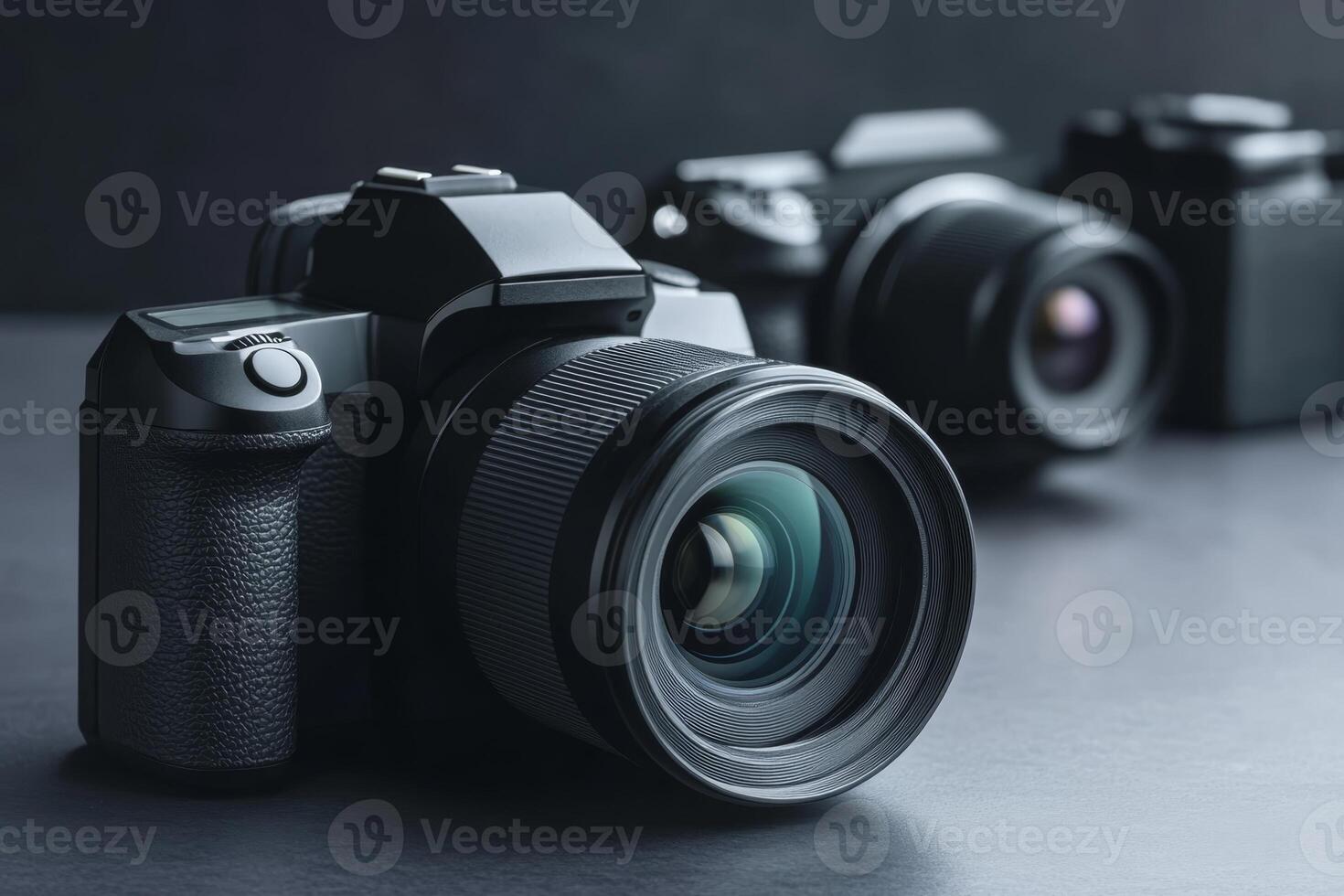 Close-up view of modern cameras arranged on a dark surface highlighting lens details and design in a studio setting photo