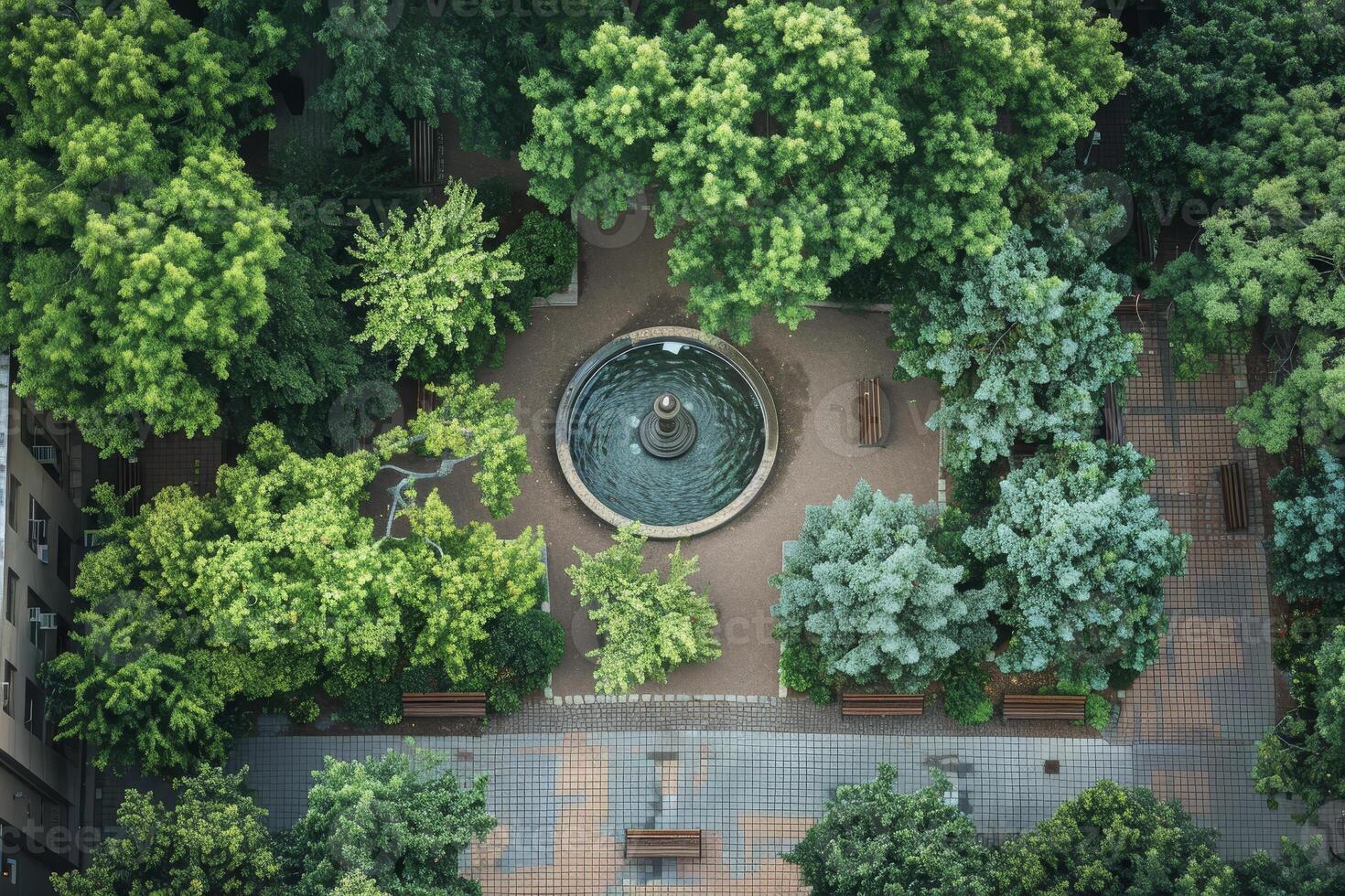 An aerial view of a park with a fountain photo