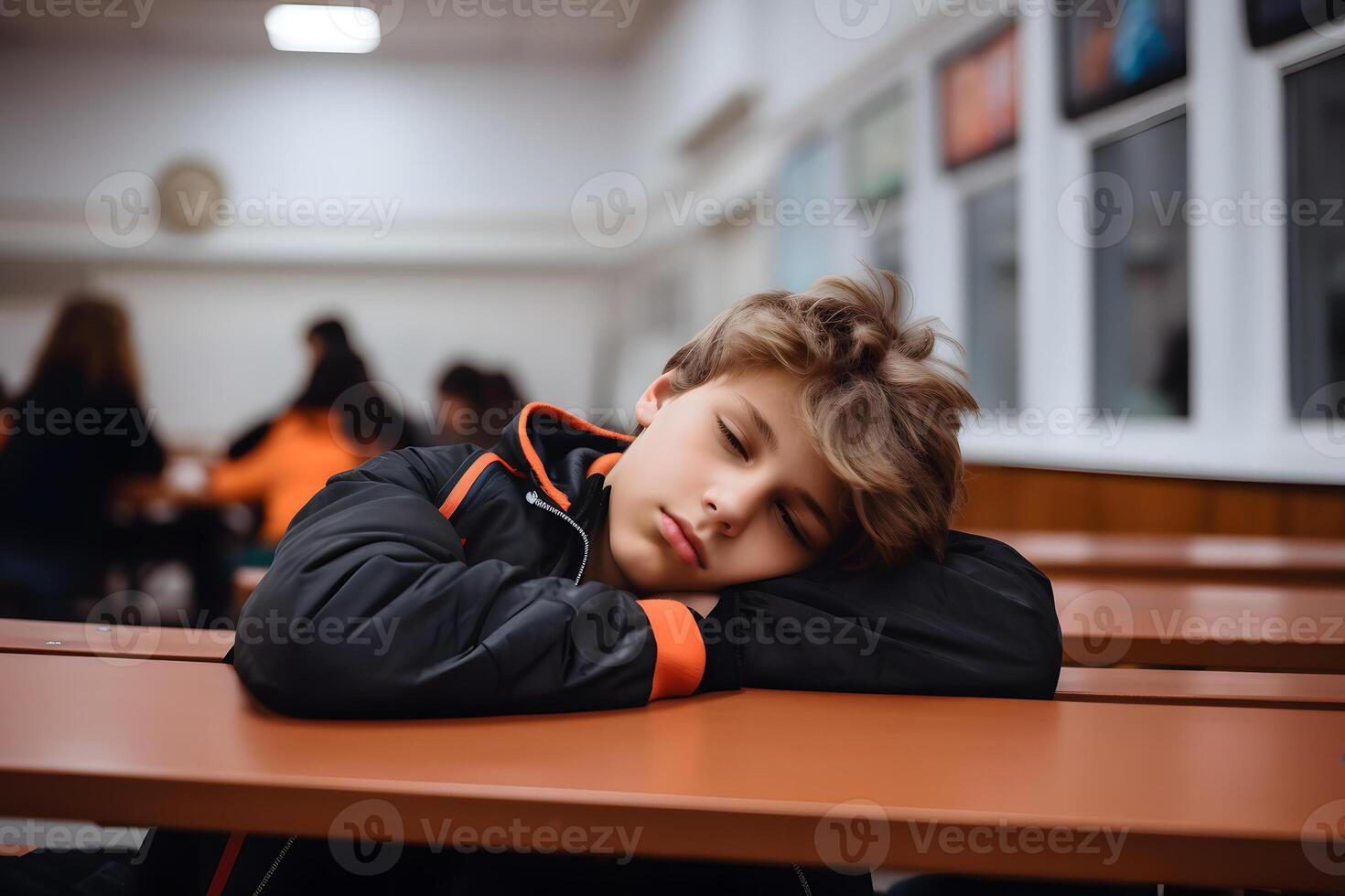 Expressive teenager boy in school, being tired and sleepy, teen emotions or teen moods concept. photo