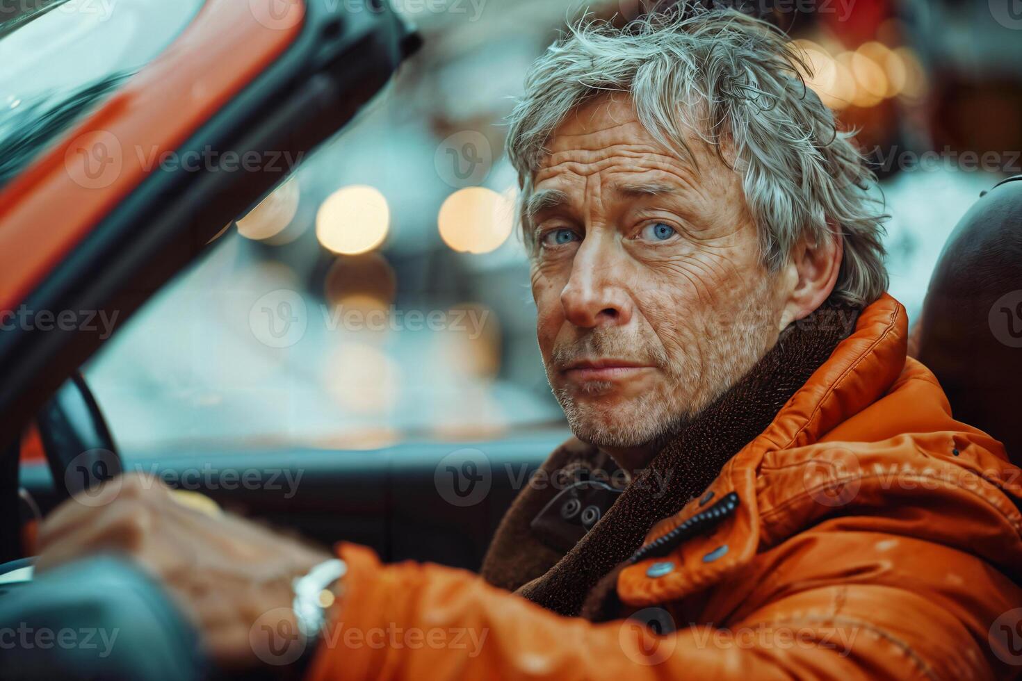 Senior Man Driving a Convertible Car in Urban Setting photo
