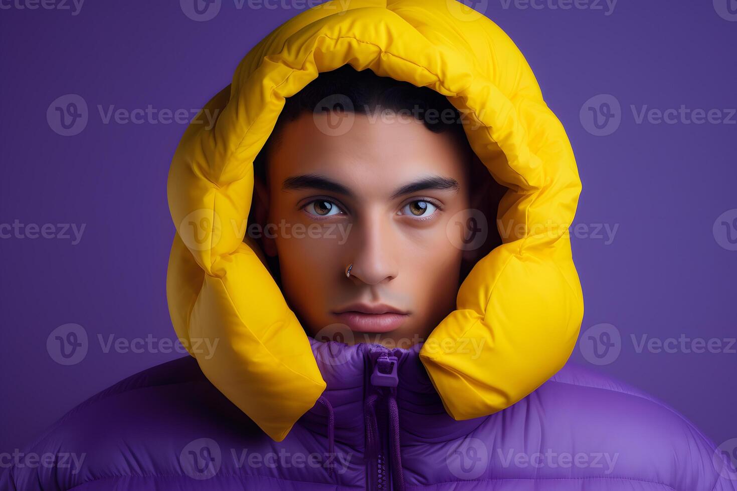 portrait of a young man wearing cold weather clothes to keep him warm. Autumn or winter outfit. Bold, vibrant and minimalist. photo