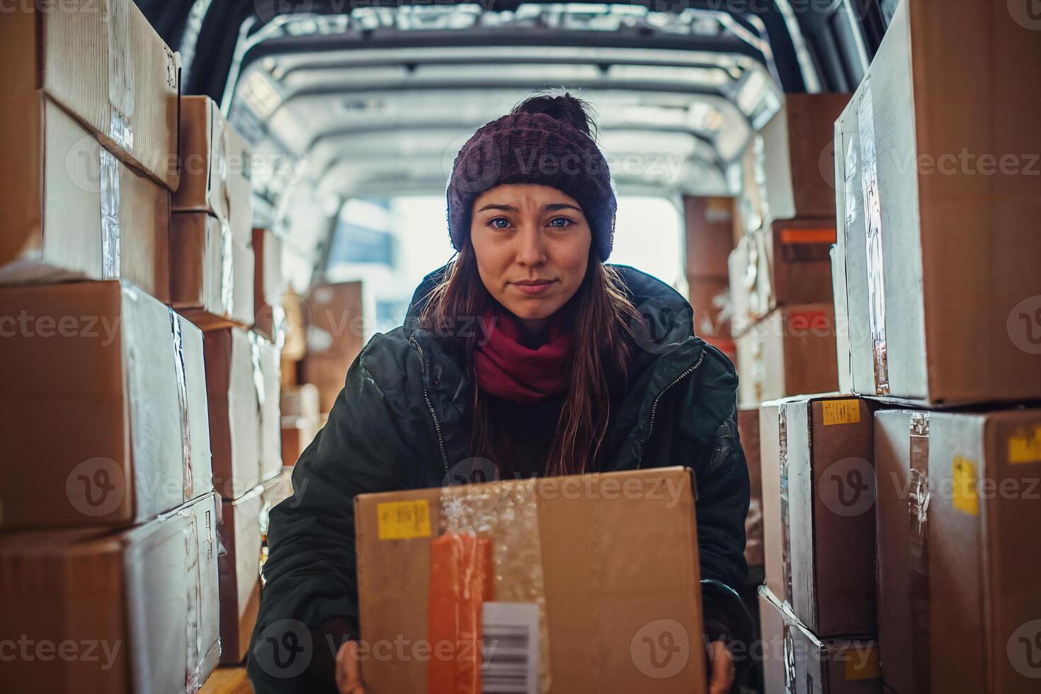 Working Class Woman Feels Discontent While Unloading Boxes photo