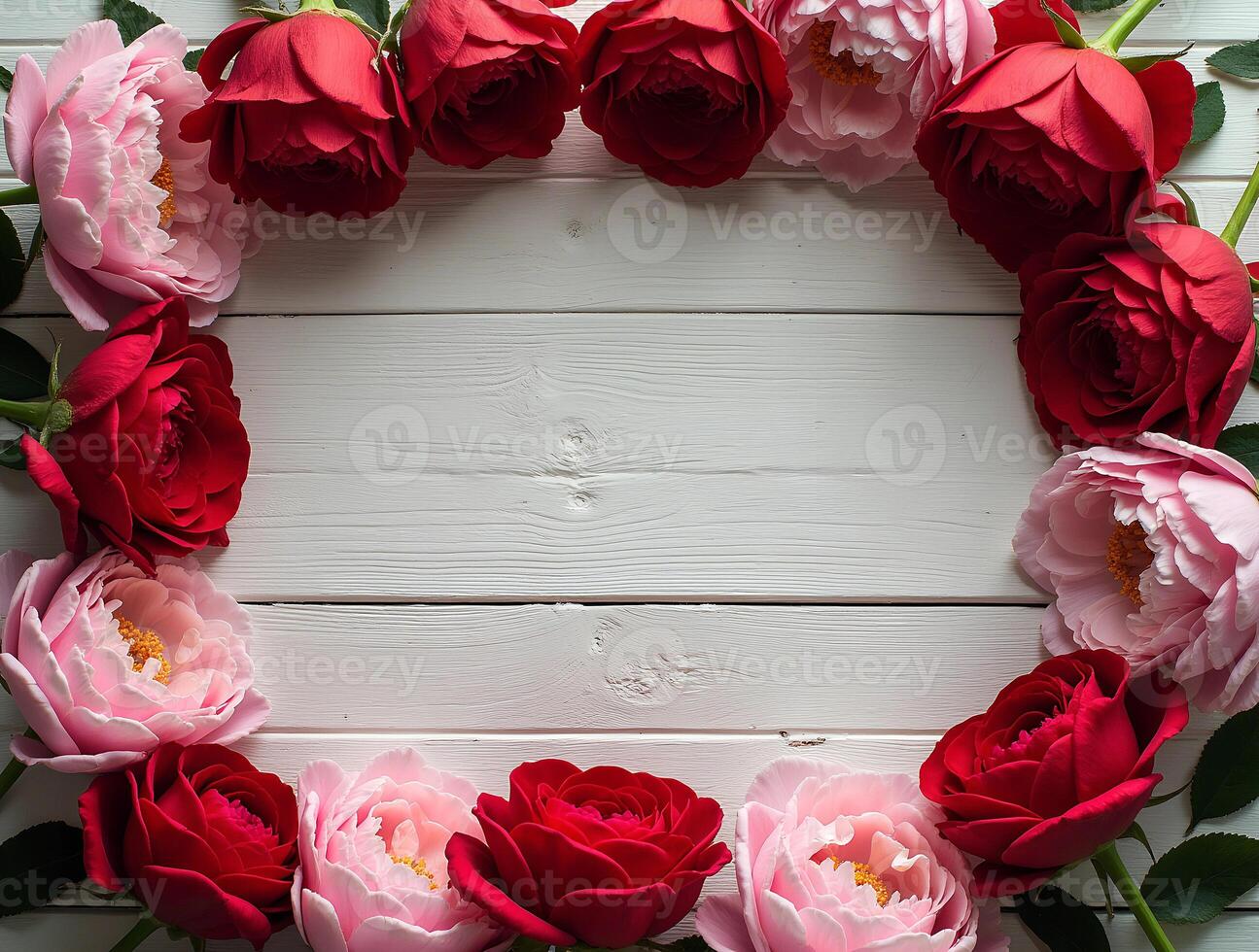 Flowers arranged in a vibrant border with red roses and pink peonies on a rustic white wooden surface for decoration or celebration photo