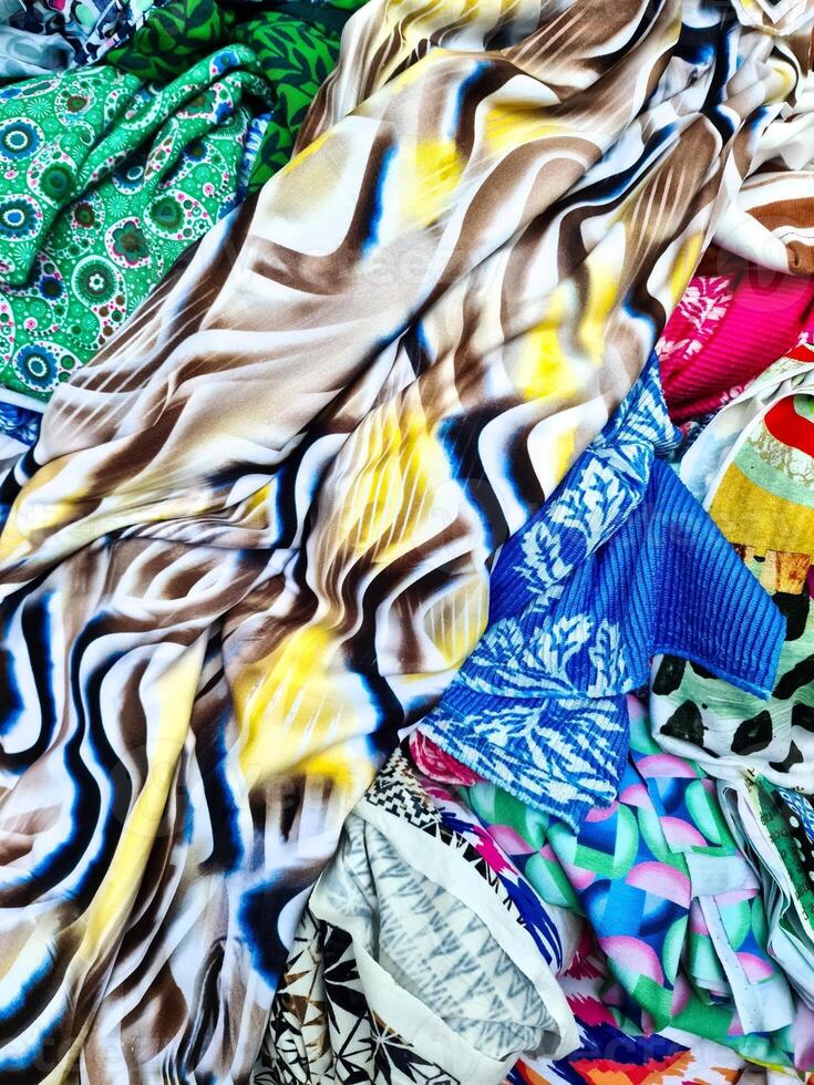Colorful fabrics showing various patterns and textures creating an abstract composition photo