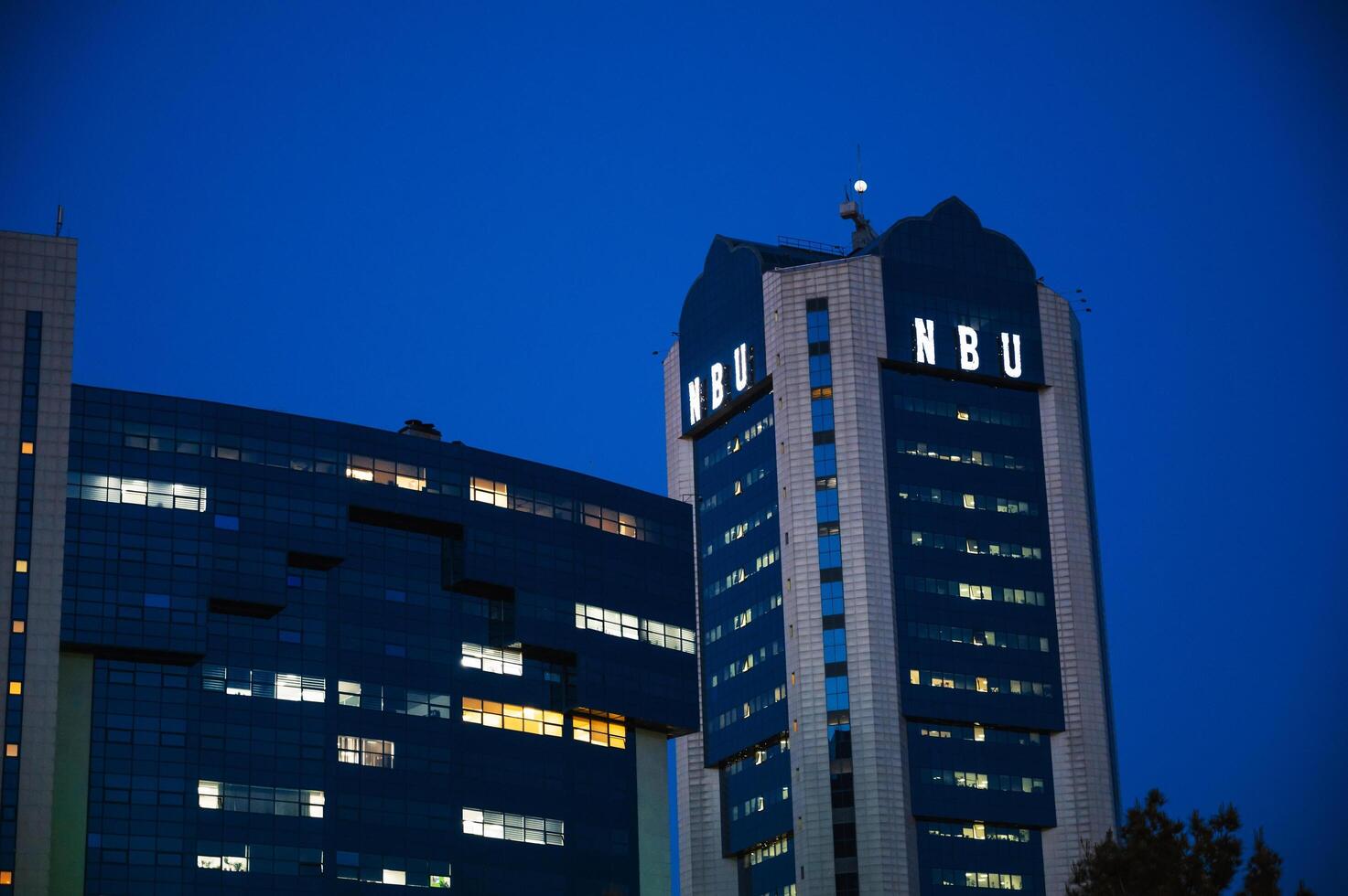 The facade of the building of National Bank of Uzbekistan in Tashkent at night. Tashkent, Uzbekistan - April 16, 2024 photo