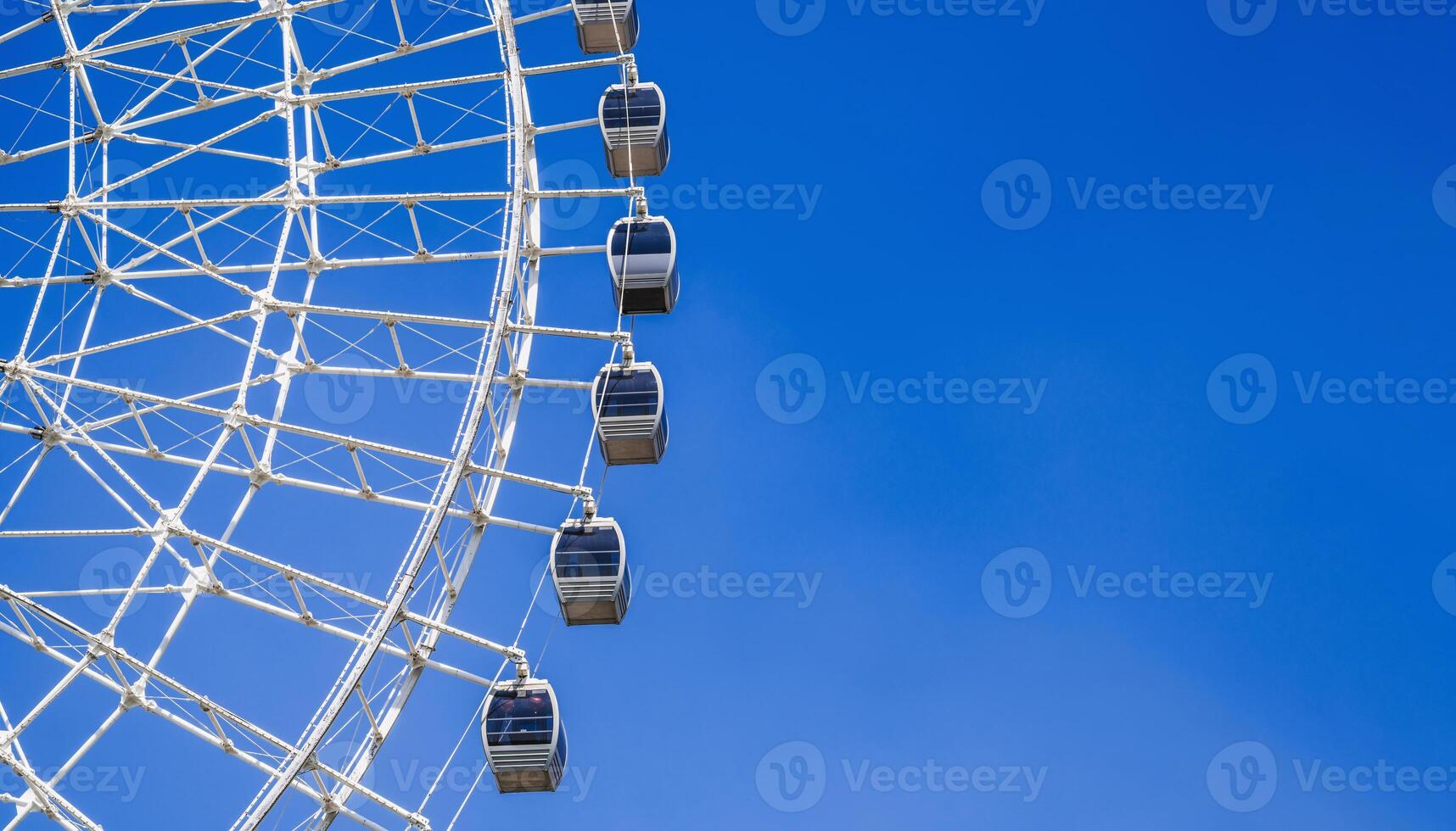 white big ferris wheel on background clear blue sky in Park with copy space photo