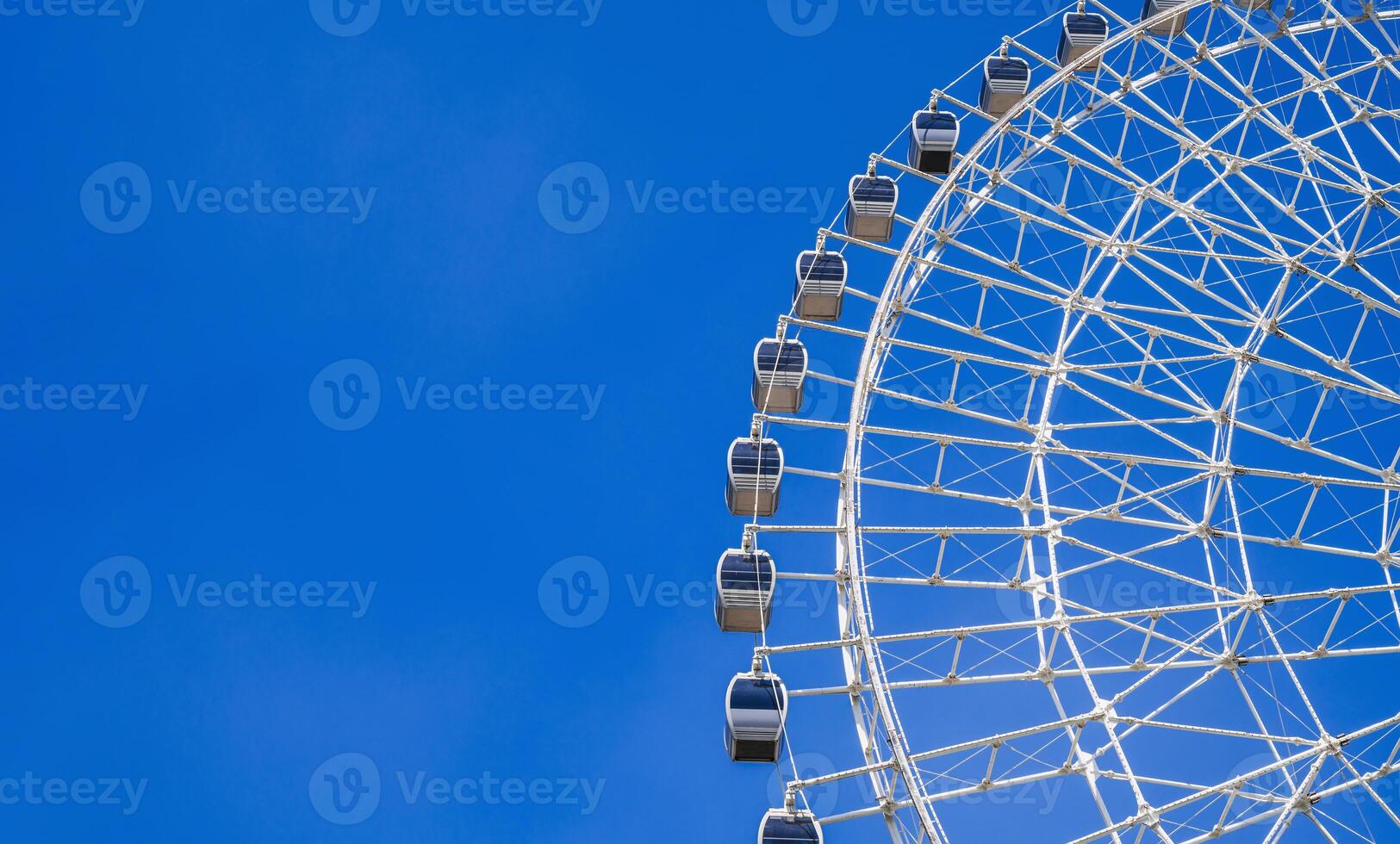 white big Ferris wheel on background a blue sky in amusement park at fair in summer with copy space photo
