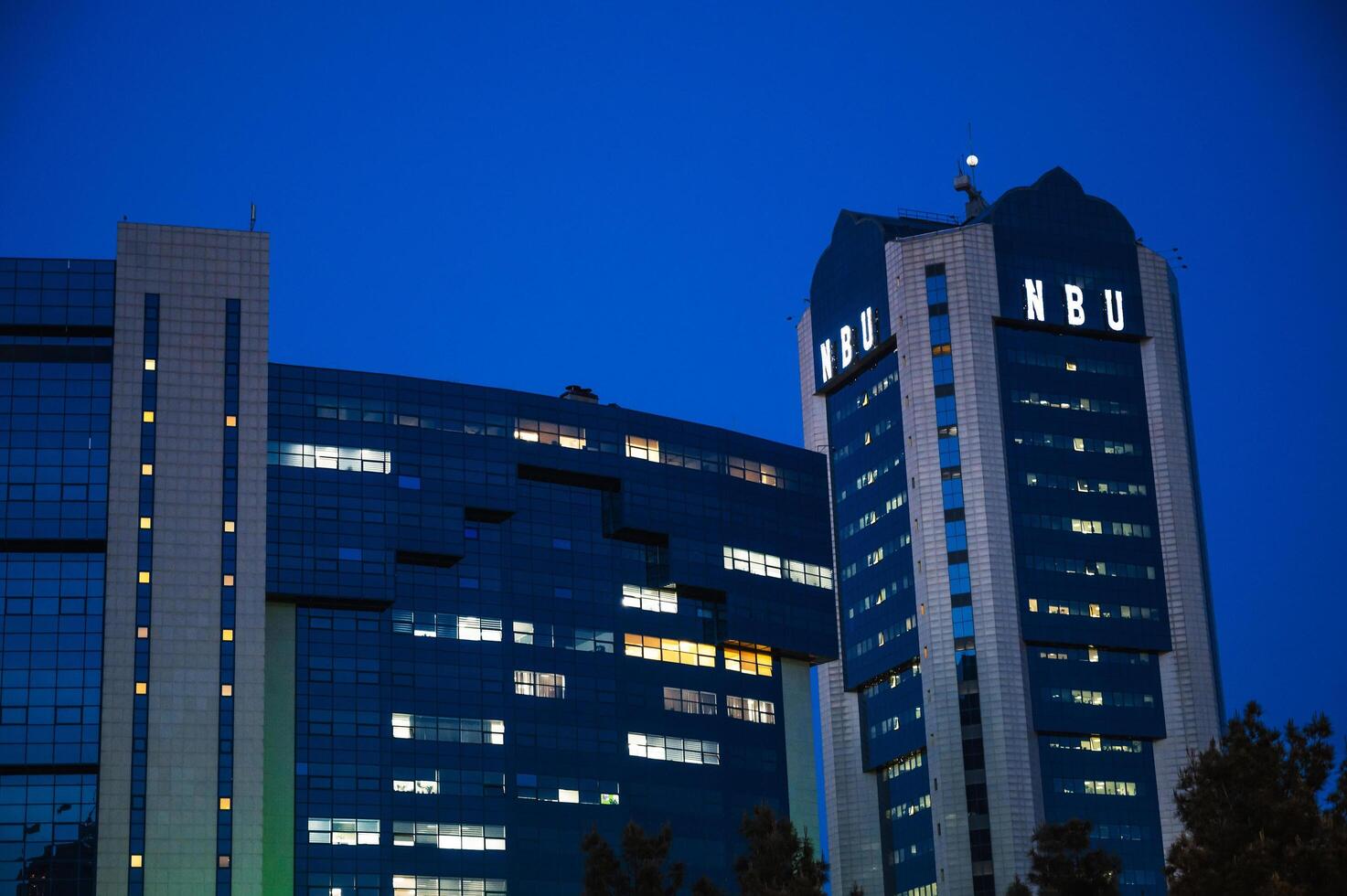 The facade of the building of National Bank of Uzbekistan in Tashkent at night. Tashkent, Uzbekistan - April 16, 2024 photo