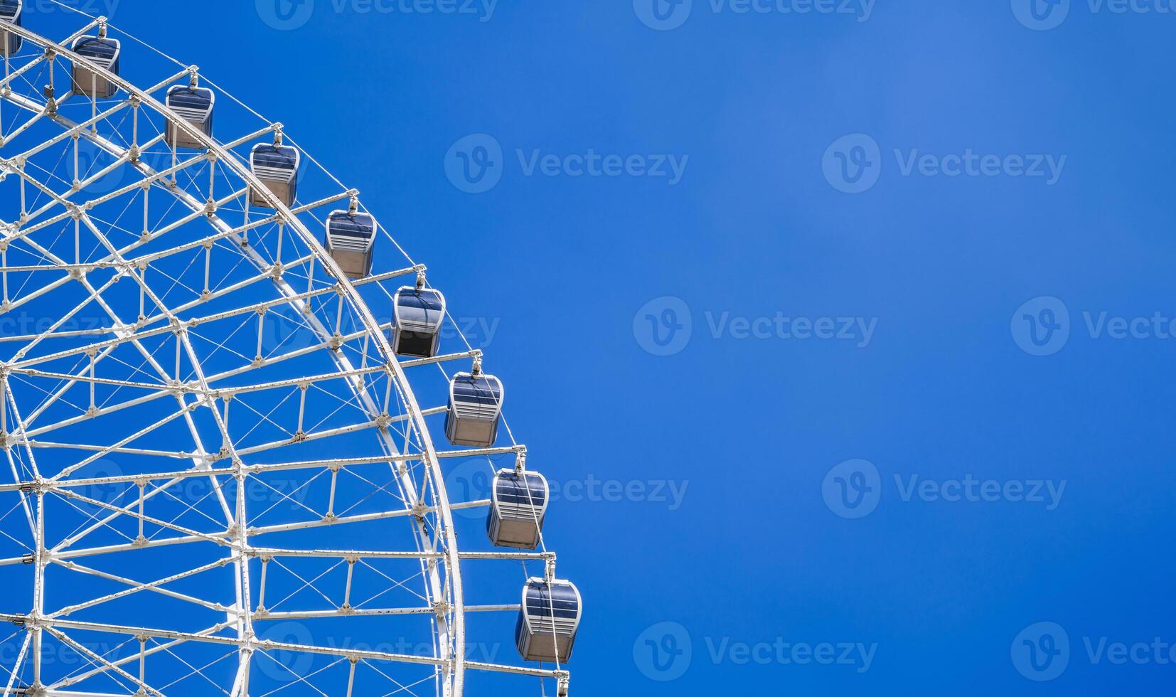 white big Ferris wheel on background clear blue sky in the amusement park in Tashkent with copy space photo