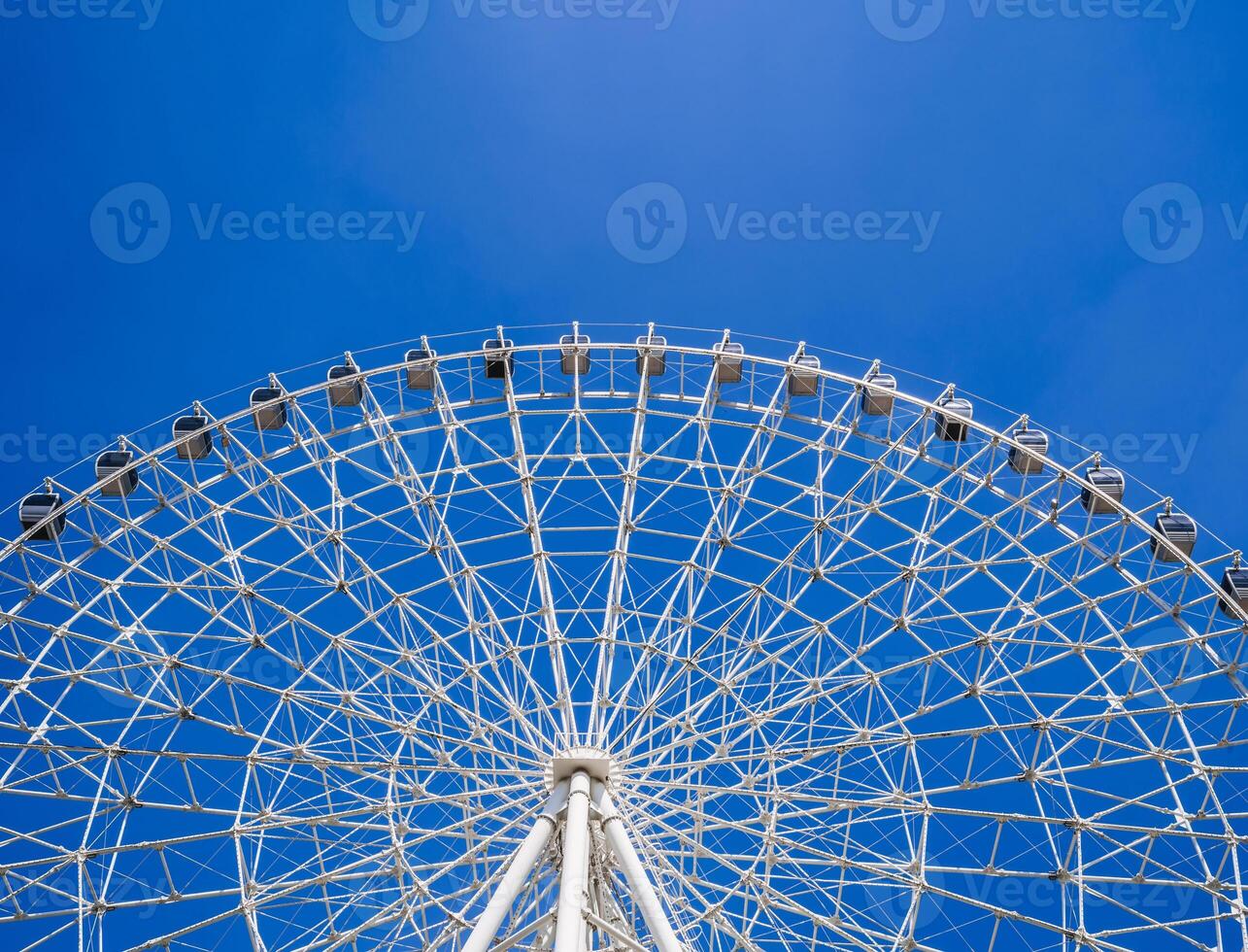 white big Ferris wheel on background a clear blue sky in amusement Navryz park in Tashkent in summer with copy space photo