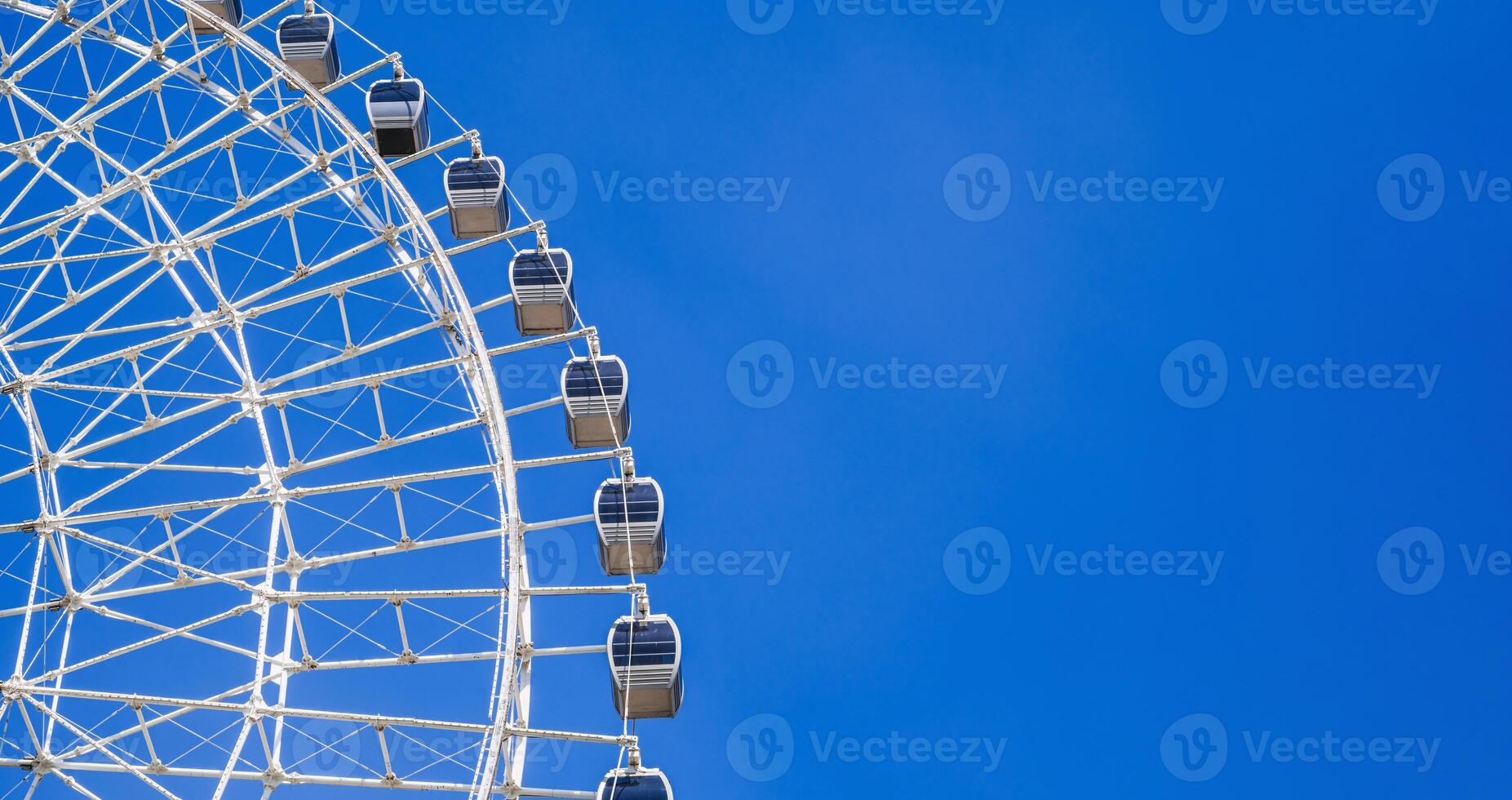 white big ferris wheel on background clear blue sky in Navruz Park in Tashkent in Uzbekistan with copy space photo