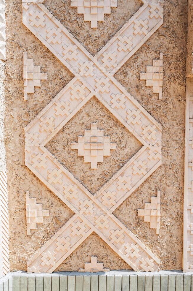 Carved stone pattern of the traditional wall decoration of an Arab building. photo