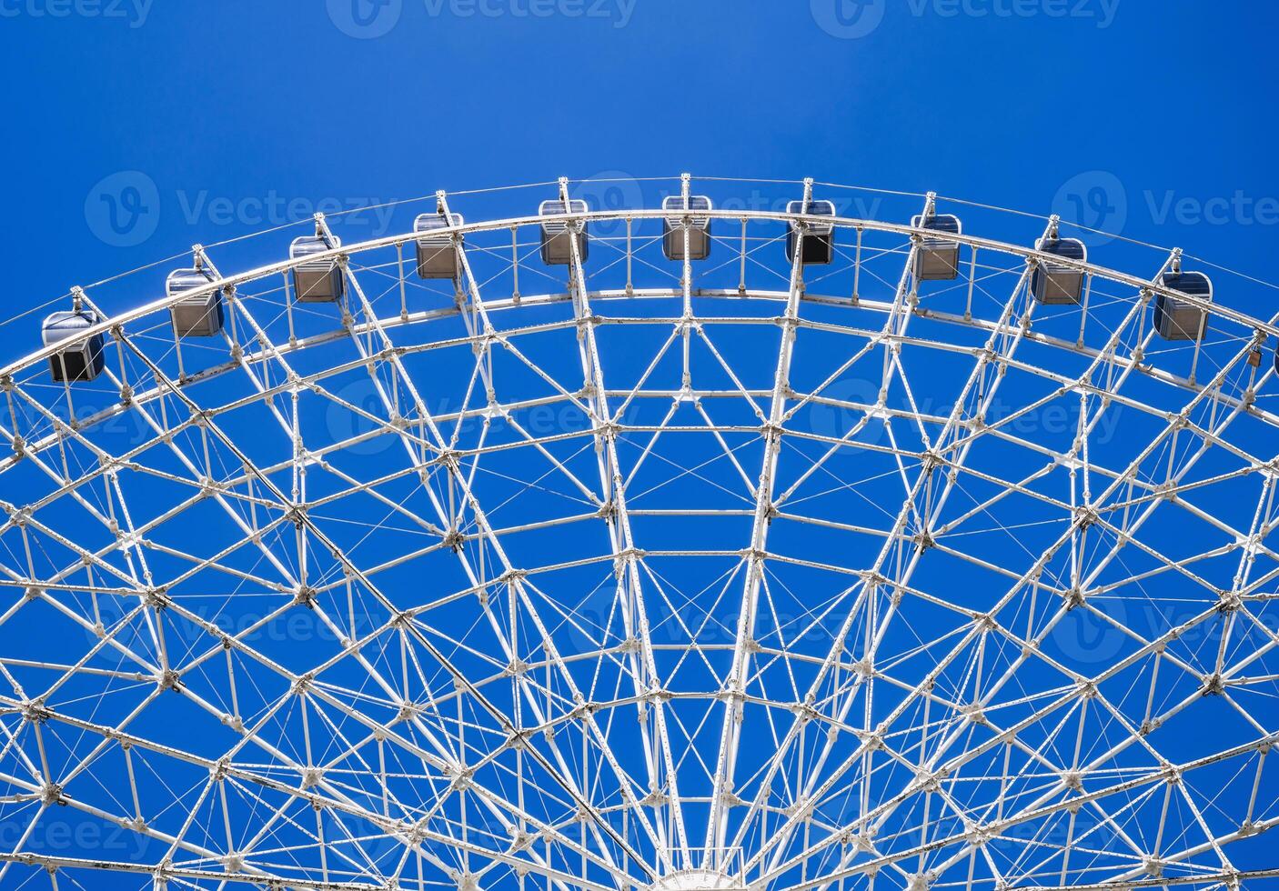 white Ferris wheel on background a clear blue sky in amusement park at fair in summer photo
