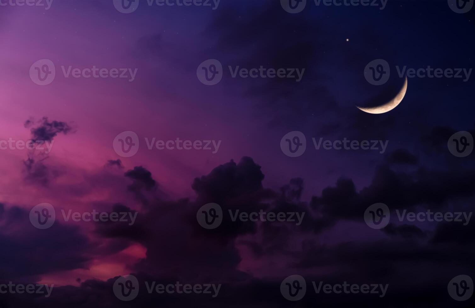 Ramadan Crescent Moon ushering in a Holy Month,Eid Mubarak Background,Night sky dark purple sky,cloudy with Waxing Crescent Moon.Concept for beginning of the month in the lunar Islamic calendar photo