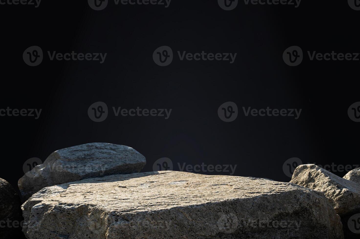 Stone rock podium pedestal on black background for spa, cosmetic product present,Minimal backdrop Studio background with grey rock sea stand and nature light on concrete wall for product showcase photo