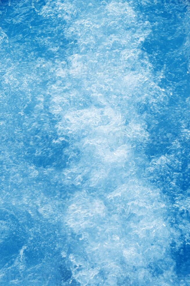 Abstract transparent water texture, bubbling clear water as textured background, purity and beauty of nature, natural ripples and waves on blue aquatic surface, nature environment photo