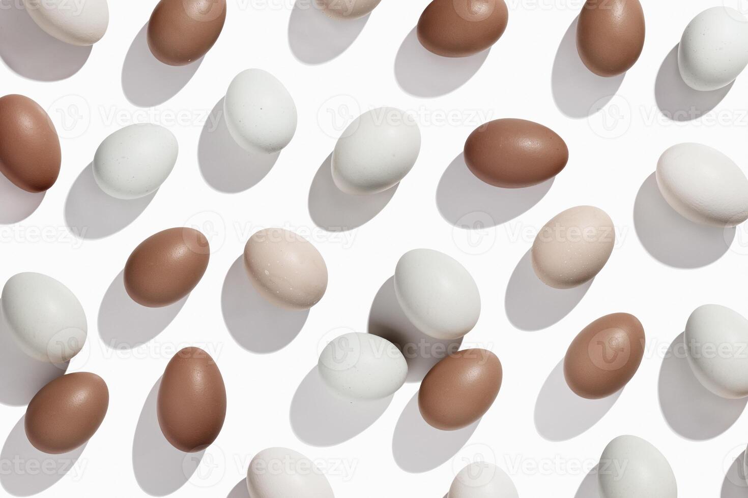 Pattern of Brown and beige Eggs with sun shadows, minimal style aesthetic holiday background, natural organic chicken eggs, breakfast ingredients, minimalist food composition, neutral tones photo