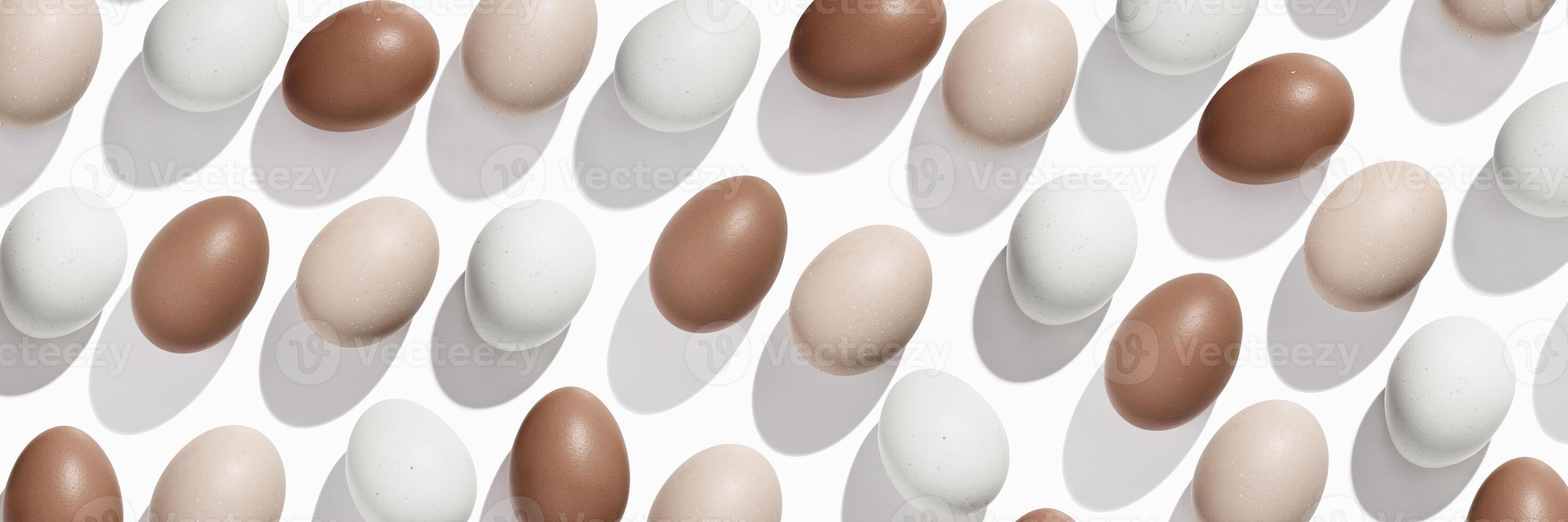 Pattern of Brown and beige Eggs with sun shadows, minimal style aesthetic holiday banner, natural organic chicken eggs, breakfast ingredients, minimalist food composition, neutral pastel color photo