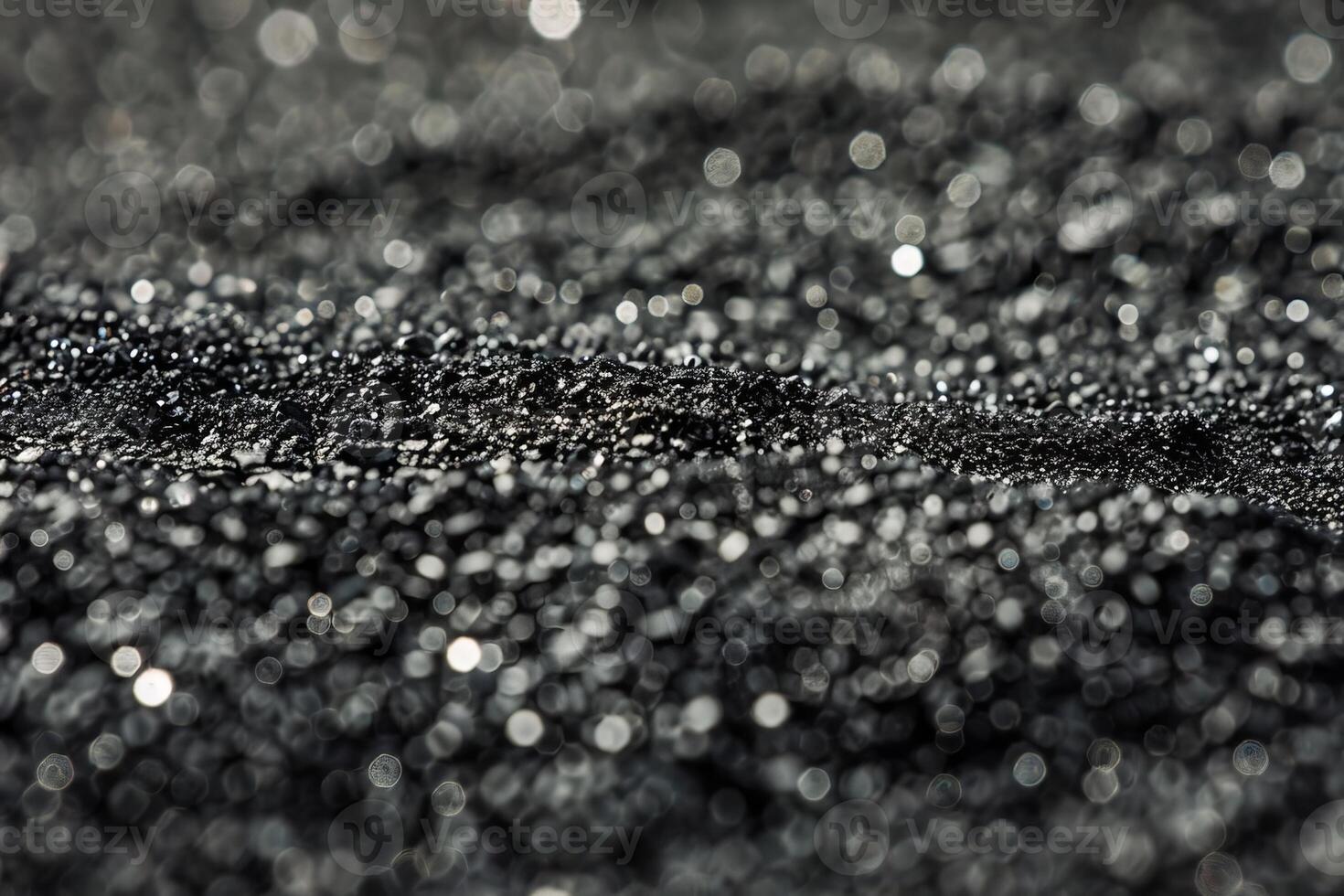 Glittering macro close-up of black sand with bokeh effect photo