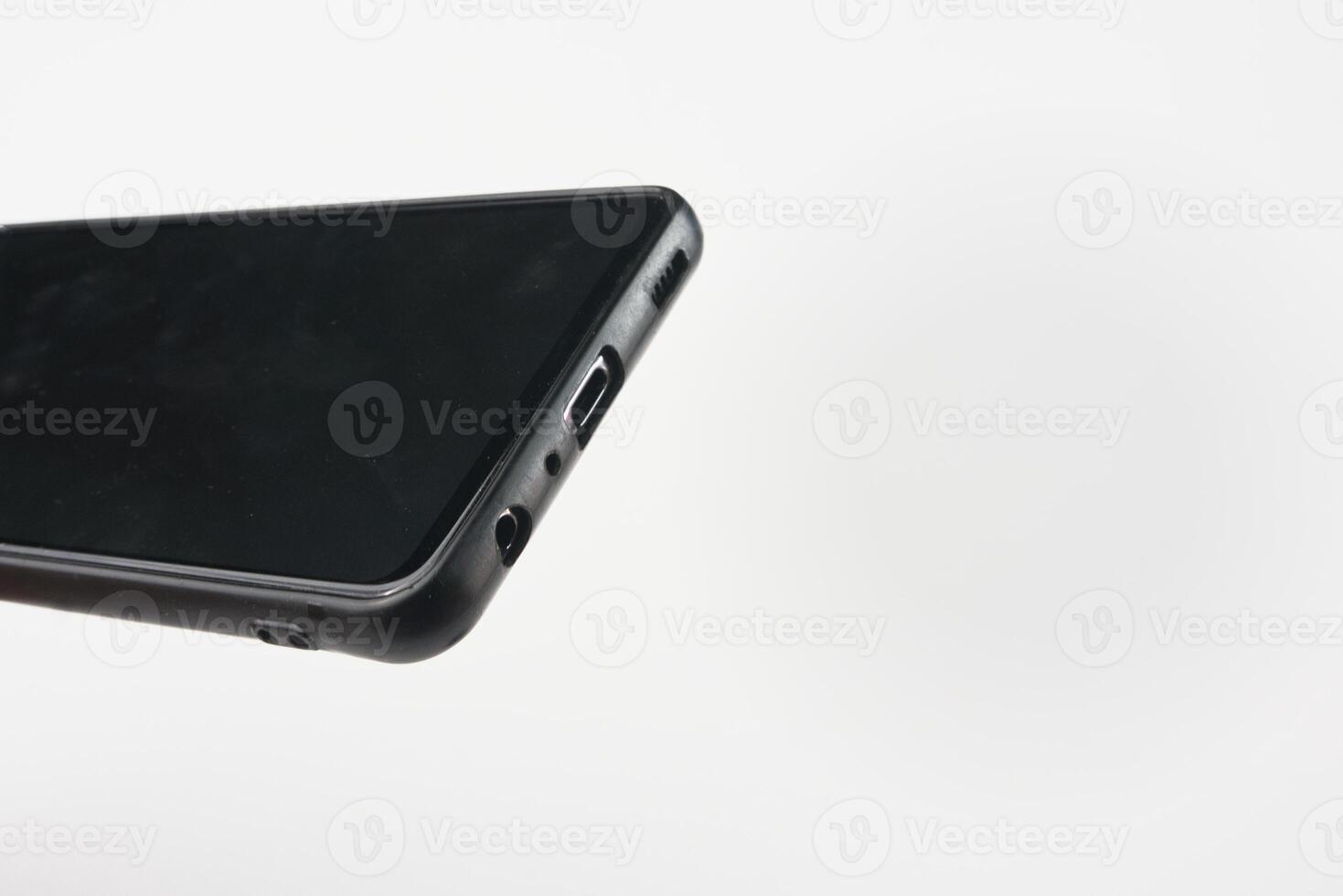 Black Smartphone Close-Up Highlighting Type C Charger Port and Headphone Jack photo