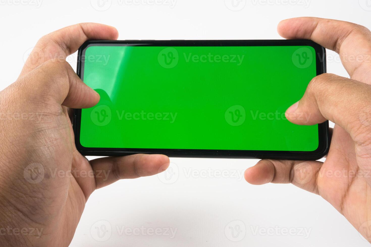 Person Holding Smartphone With Green Screen Suitable for Customization and Design photo