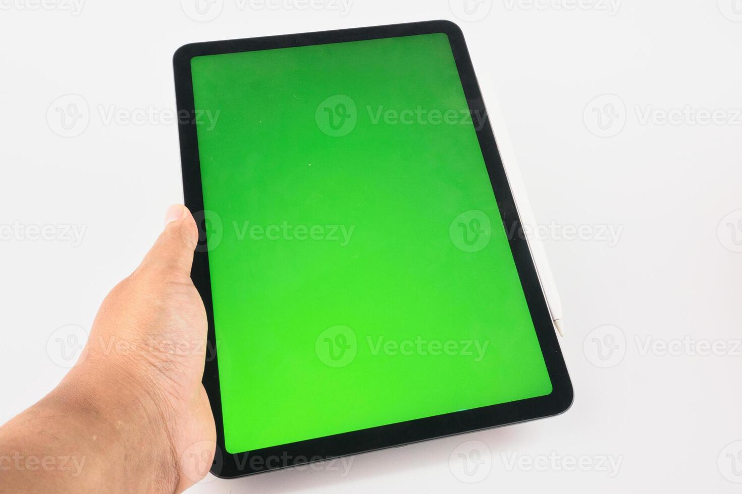 Hand Holding Tablet with Green Screen Display and Stylus Attached photo