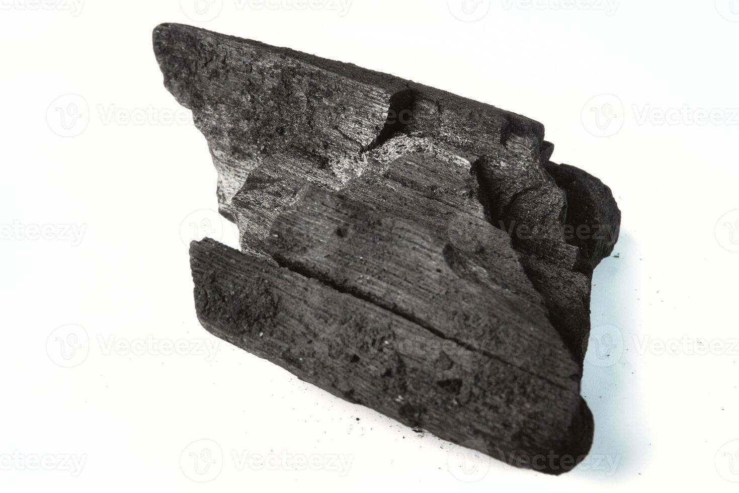 Close-Up of a Natural Charcoal Piece Isolated on a White Background photo