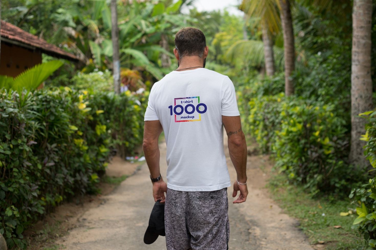 Man Walking on Tropical Path, Back View, White T-Shirt Mockup psd