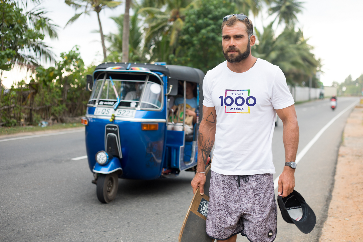 Man with Skateboard and T-Shirt Mockup in Tropical Setting psd