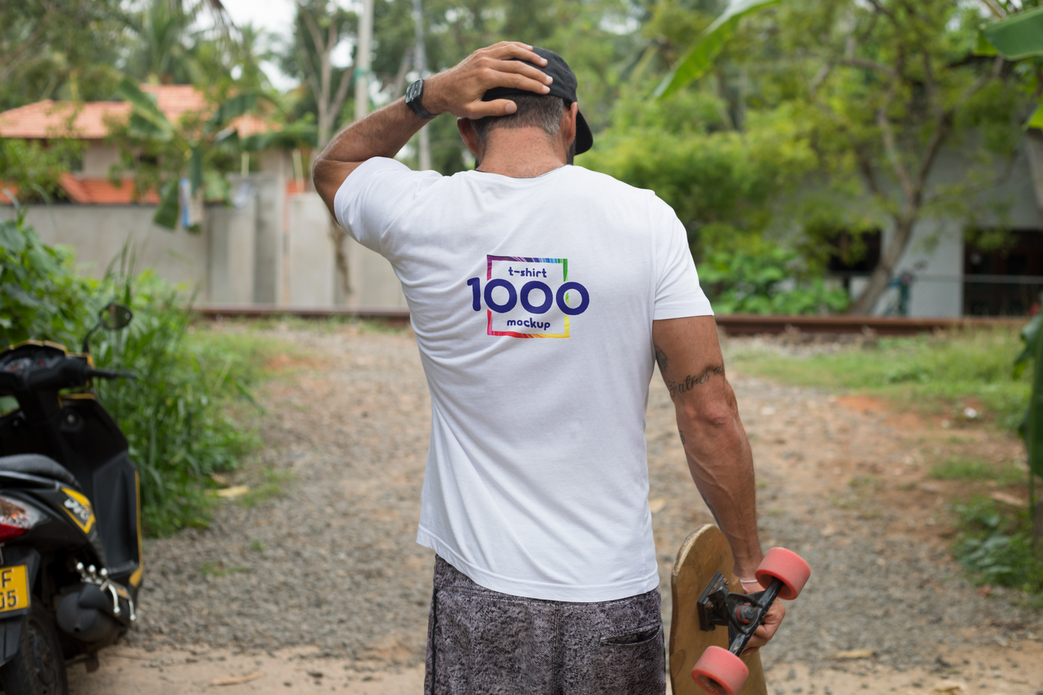 Man with T-Shirt Mockup and Skateboard Outdoors psd