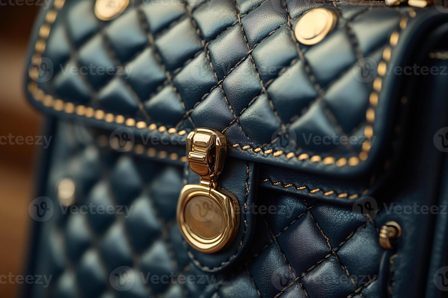 Close up of quilted leather handbag showing golden clasp and stitching photo