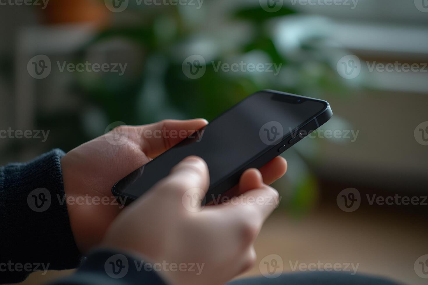 Close up of hands holding smartphone with blank screen photo