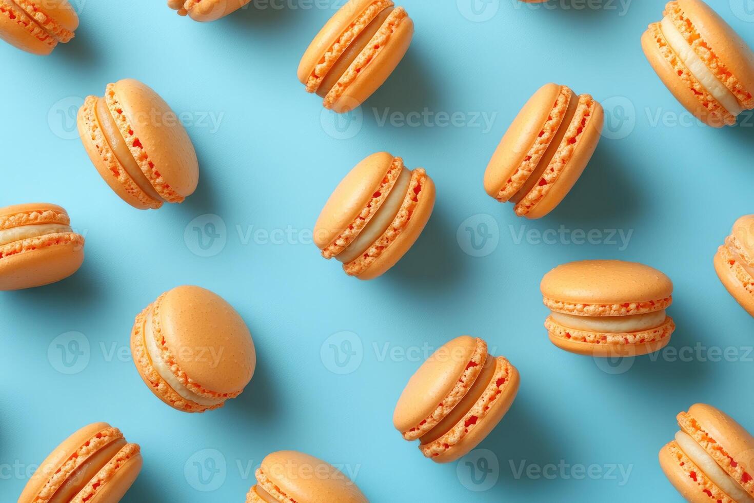 Orange macarons forming a pattern on a light blue background photo