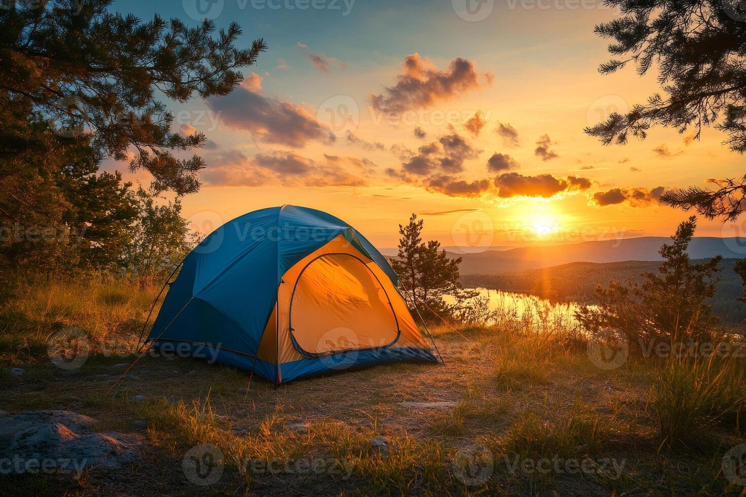 Illuminated tent overlooking tranquil lake at sunset embraces the wilderness photo