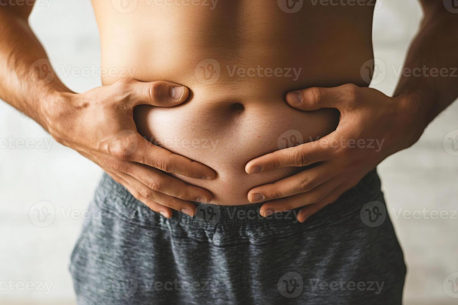 Overweight man grabbing his belly fat photo