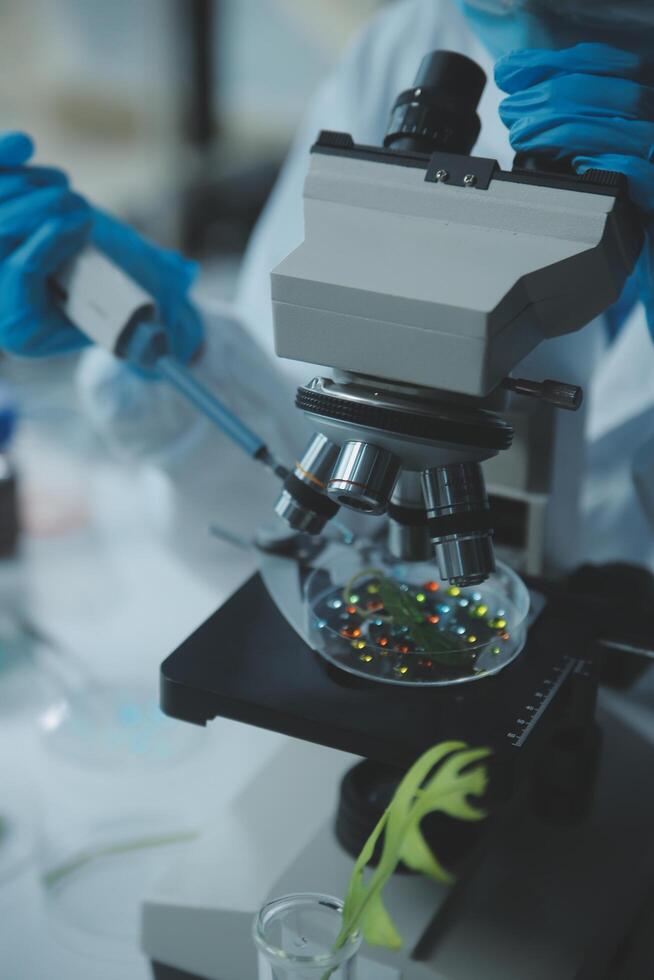 A person in a lab coat is looking at a microscope photo