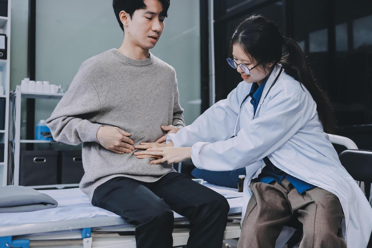 A doctor examining a patient's stomach photo