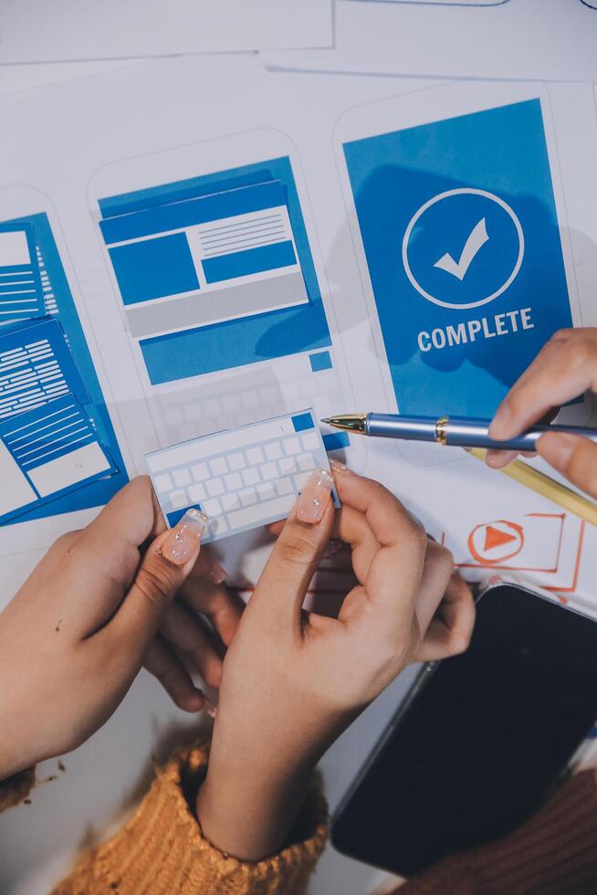 A person is holding a keyboard and a pen with a blue check mark on it photo