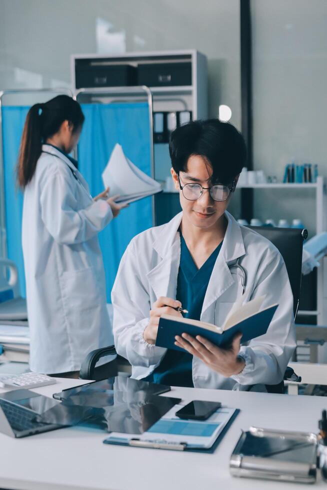 A man in a lab coat is reading a book photo