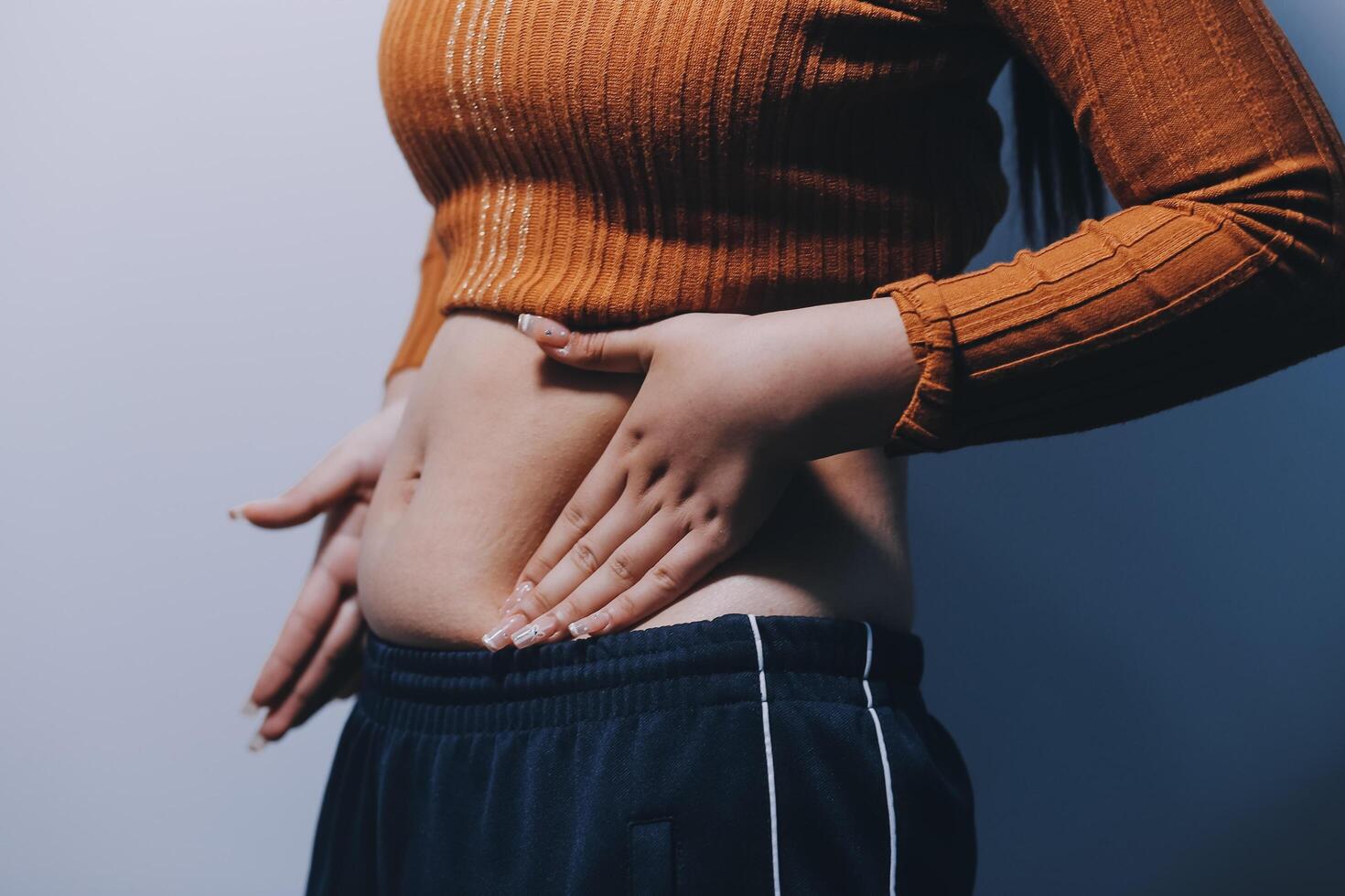 A woman with her hands on her stomach photo