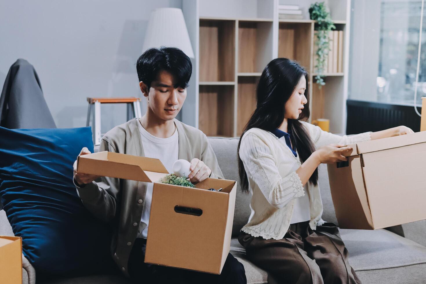 A couple moving boxes on a couch photo