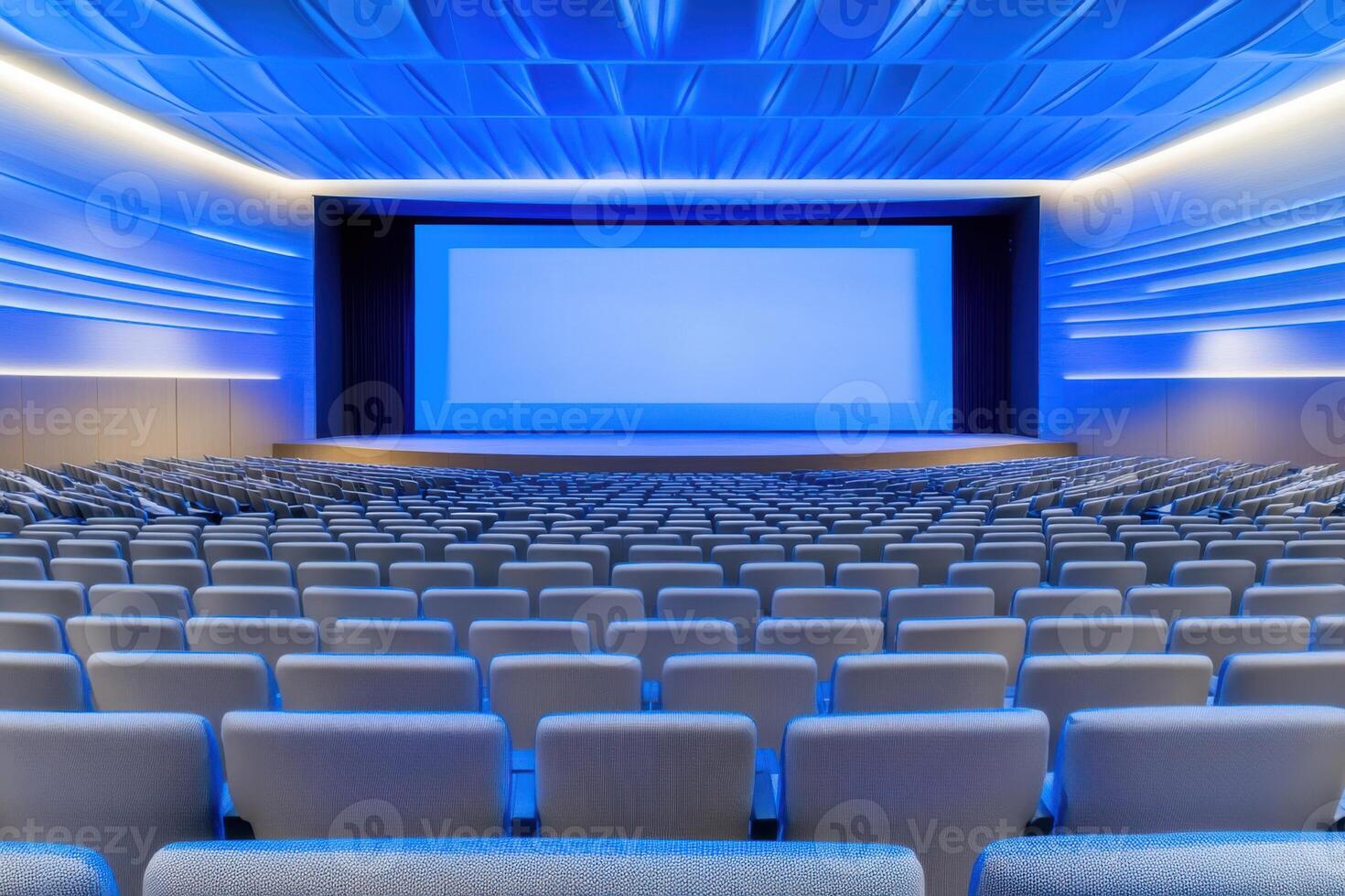 Elegant corporate conference setup featuring panel discussion with bright stage lighting, large presentation screen, and organized seating arrangement photo