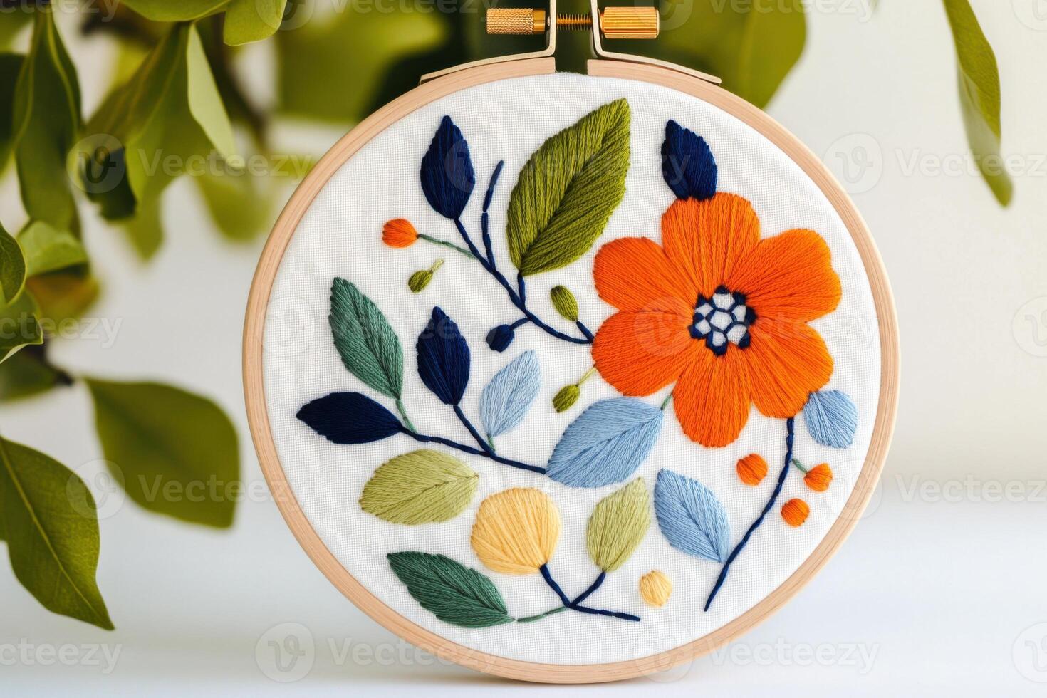 Handmade crewel embroidery wall art showcasing intricate nature-inspired patterns in a wooden hoop with soft warm lighting photo