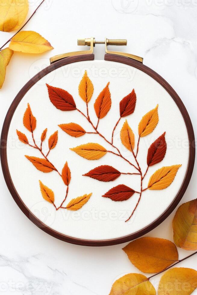 Handmade crewel embroidery wall art featuring intricate nature-inspired leaf patterns in soft warm lighting photo