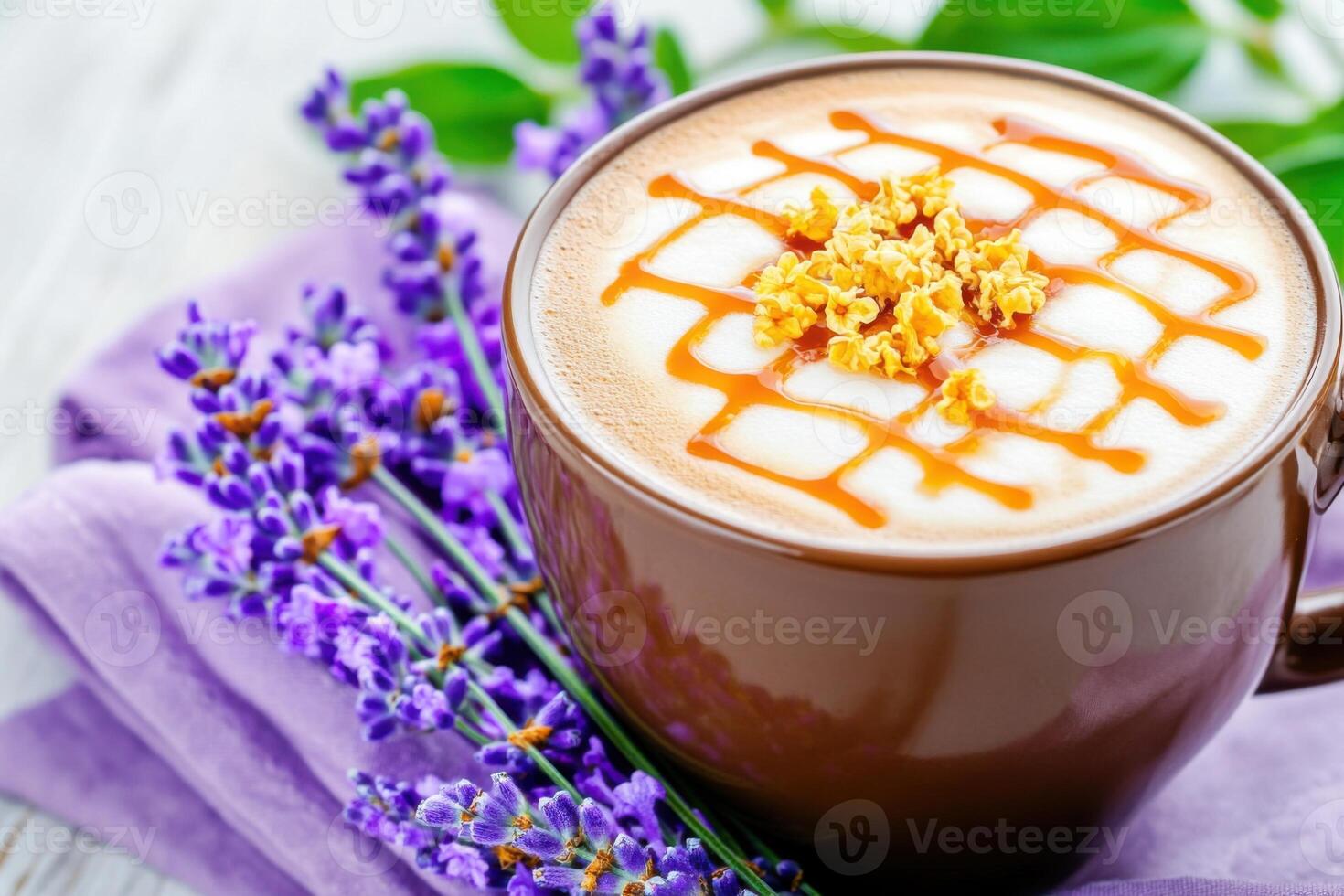 Close-up view of a latte topped with golden caramel drizzle, served in a mocha brown cup on a lavender napkin for a cozy aesthetic photo